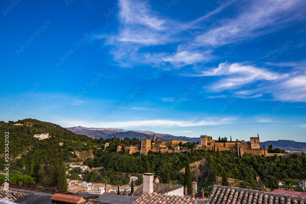 Elevated panoramic view of the city of Granada, Andalusia, Spain. Alhambra lit by setting sun light on the other hill