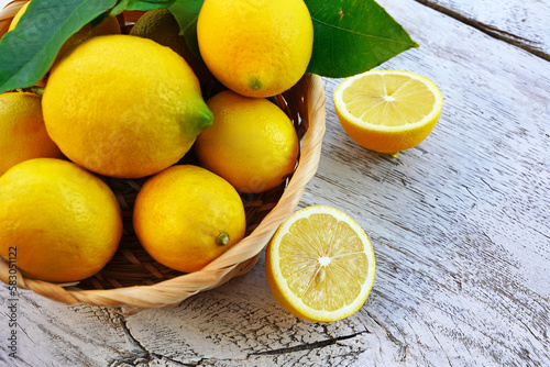 lemons in basket on a wooden background