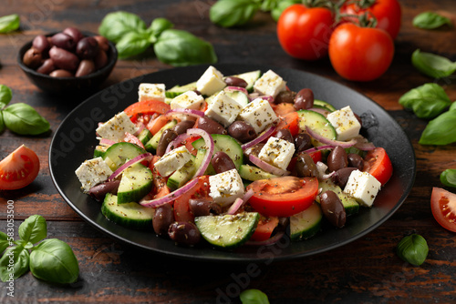 Greek salad with fresh vegetables  feta cheese  kalamata olives  dried oregano  red wine vinegar and olive oil. Healthy food.