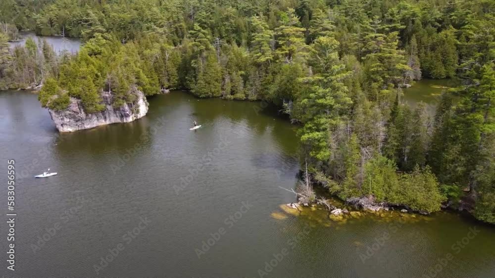 Drone circling over kayakers on a sunny lake in Guelph. Drone circling over kayakers on a sunny lake in Guelph.