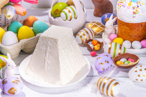 Traditional orthodox Easter paskha curd cake. Simple Easter vanilla cottage cheese dessert, with Easter eggs, spring flower and decorations copy space