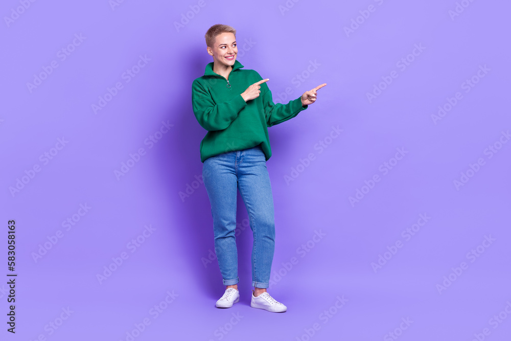 Fototapeta premium Full length portrait of pretty positive person look indicate fingers empty space isolated on purple color background