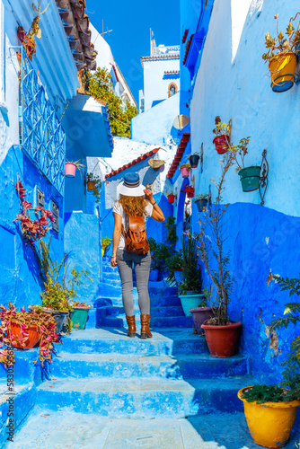 Tour tourism at Chefchaouen,  Morocco- Woman in medina of blue street city © M.studio