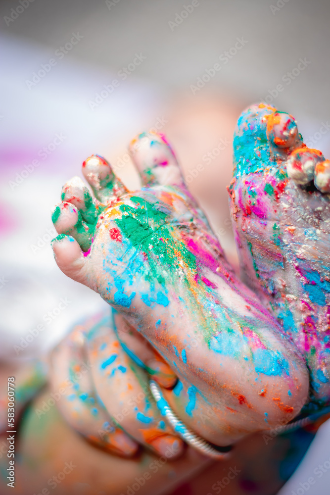 infant little colorful feet at holi from unique angle infant little colorful feet at holi from unique angle