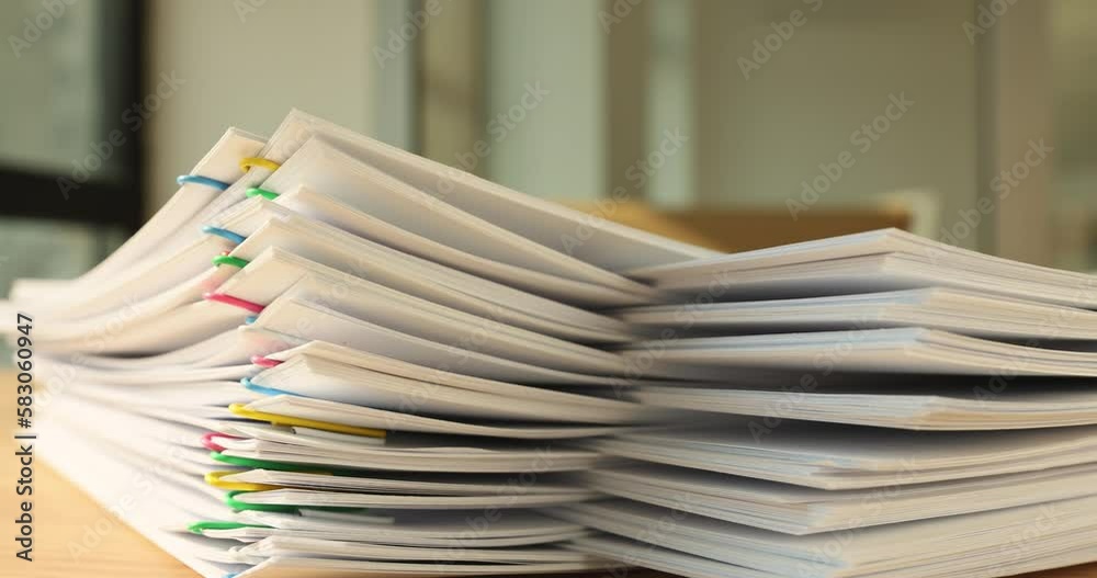 A stack of paper with colored paper clips, close-up