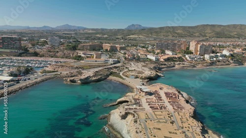 flight over the blue sea with the skyline of el campello in spain with the port and the museum photo