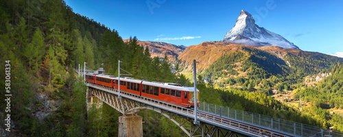 Zermatt, Switzerland. Gornergrat red tourist train on the bridge and Matterhorn peak panorama in Swiss Alps, benner photo