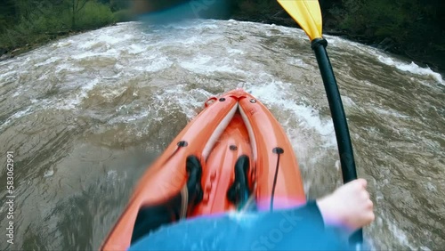 An extreme and exciting sport is rafting on the river in a kayak.