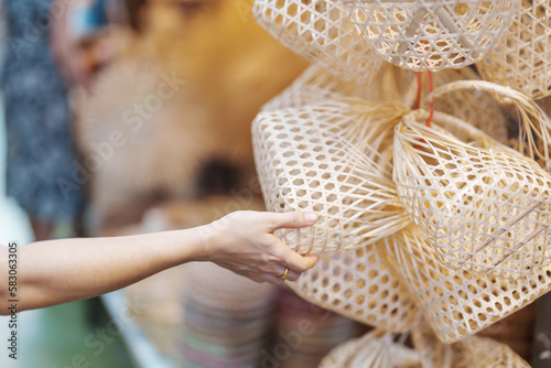 Photography Tourist hand holding Craft bamboo basket in Chatuchak Weekend Market, landmark and popular attractions in Bangkok, Thailand