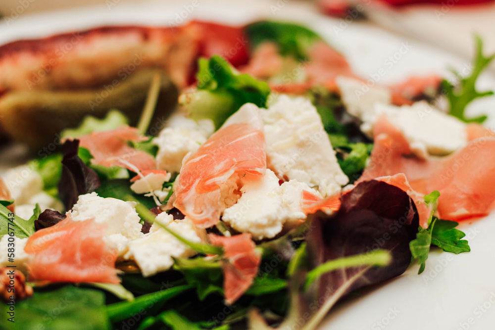 Salad with feta cheese with arugula and fried sausage. Salad with feta cheese with arugula and fried sausage.