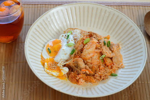 a plate of kimchi fried rice served with fried egg 