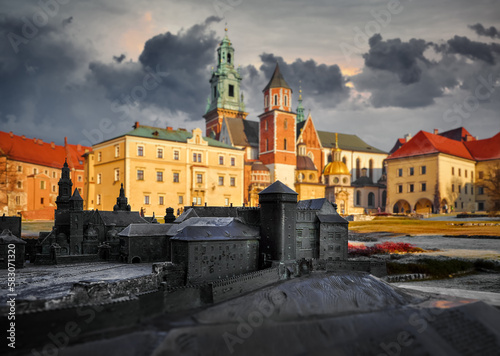 Wawel castle in Krakow, Poland. Towers of vintage fortress and Catholic temple. Picturesque territory autumn day with evening warm sunshine lighting. Sky dramatic clouds