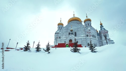Belogorsky St. Nicholas Orthodox Missionary Monastery. Russia, Perm Krai, Belaya Gora. The temple on the hill in winter. Monastery on the background of snow. 4K photo