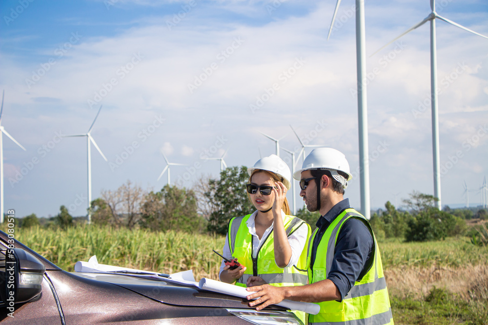 engineer team working in wind turbine farm. Renewable energy with wind generator by alternative energy concept. engineer team working in wind turbine farm. Renewable energy with wind generator by alternative energy concept.