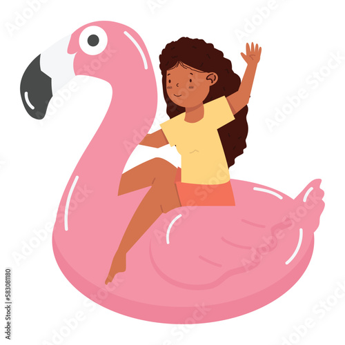 Kid girl sitting on pink flamingo float
