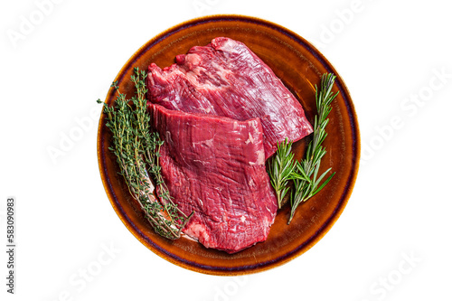 Two Flap or Flank raw beef steaks on a rustic plate with herbs. Isolated, transparent background.