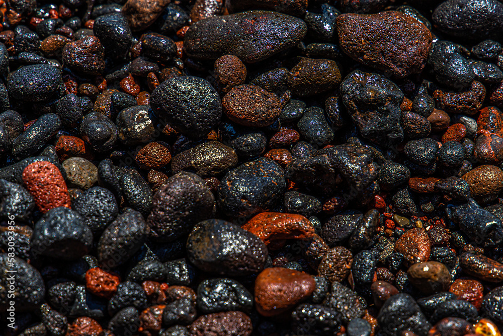 black and red volcano beach stones in Santorini, Greece black and red volcano beach stones in Santorini, Greece