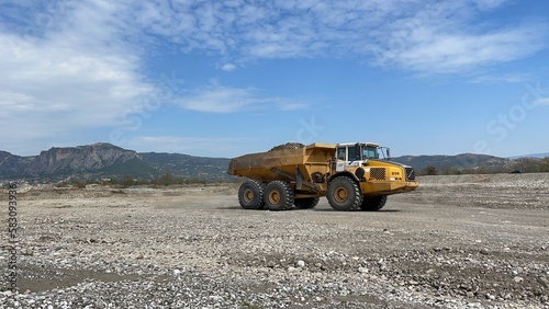 Dumper working at a huge mining site, production of aggregates. photo