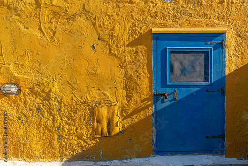 old blue door in orange wall