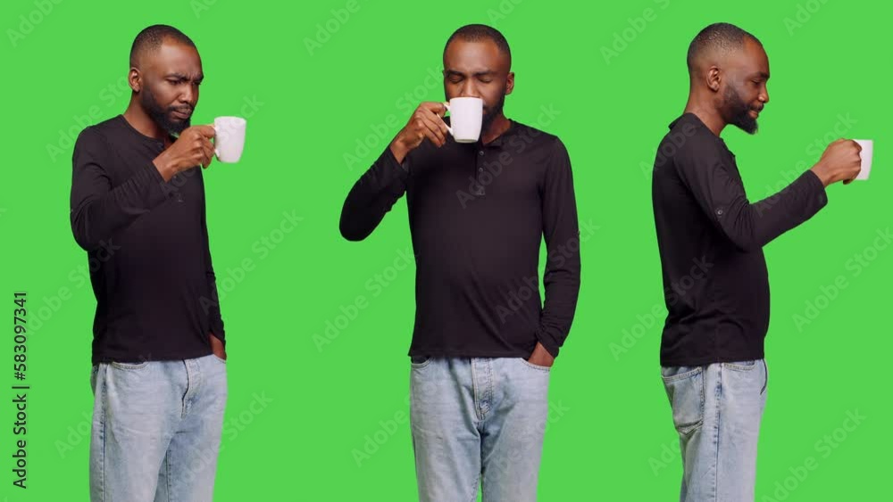 Young adult enjoying cup of caffeine beverage on camera, drinking coffee over greenscreen backdrop. Male person feeling confident and serving hot refreshment, leisure activity. Young adult enjoying cup of caffeine beverage on camera, drinking coffee over greenscreen backdrop. Male person feeling confident and serving hot refreshment, leisure activity.