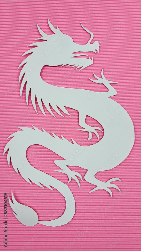 Paper white dragon on pink corrugated paper background. The concept of the new year.