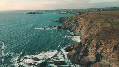 Ocean waves crashing on wild coastline in South Devon, England photo