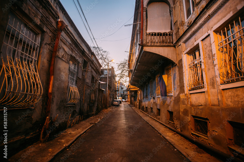 Fototapeta premium Old shabby houses in the slum district at Tbilisi at night