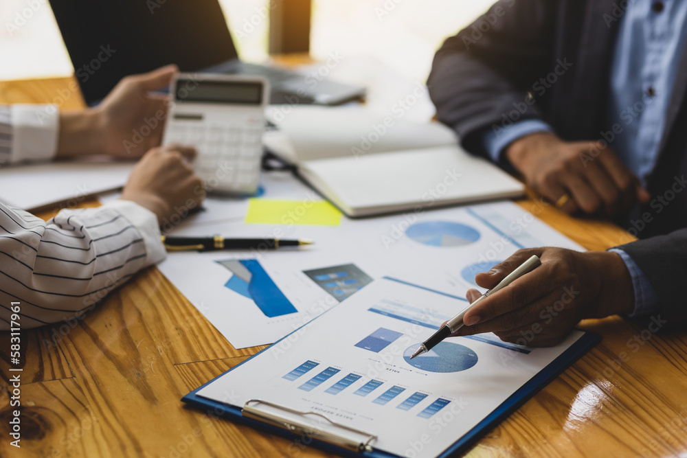 Business finance consultants discuss analysis of marketing reports to assess the profitability of the business.