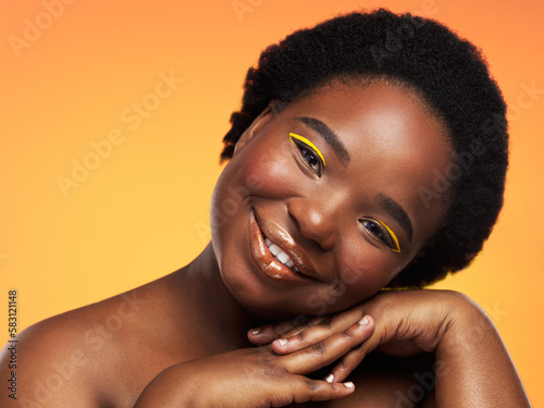 Embrace who you are and youll be happy. Studio shot of a beautiful young woman posing against an orange background.