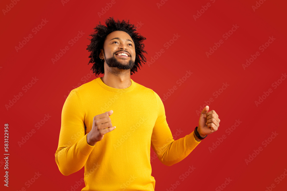 Extremely excited overjoyed man with beard shouting making yes gesture, amazed with his victory, triumph. Indoor studio shot isolated on red background Extremely excited overjoyed man with beard shouting making yes gesture, amazed with his victory, triumph. Indoor studio shot isolated on red background