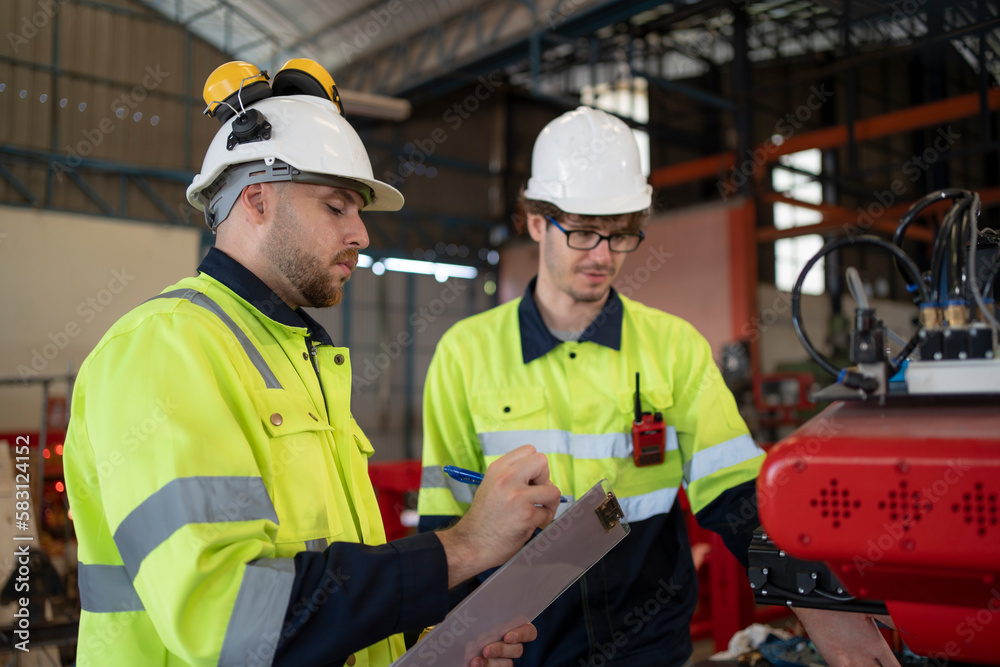 Maintenance engineer repair and programing robotic arm in factory. Maintenance engineer repair and programing robotic arm in factory.