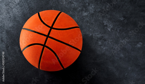 The ball is in your court. High angle shot of a single basket ball placed on top of a dark background inside of a studio.