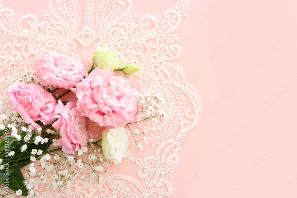 Top view image of delicate flower over pastel background