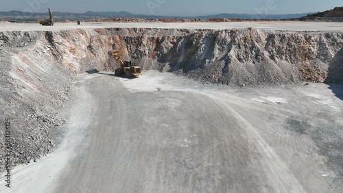 Work at a huge limestone quarry, production of aggregates., heavy machines in action, transferring the material, crusher complex, travel with ships