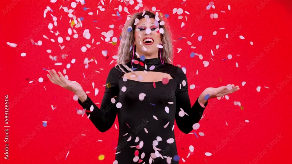 Drag queen person surrounded by confetti flying in the air Drag queen person surrounded by confetti flying in the air