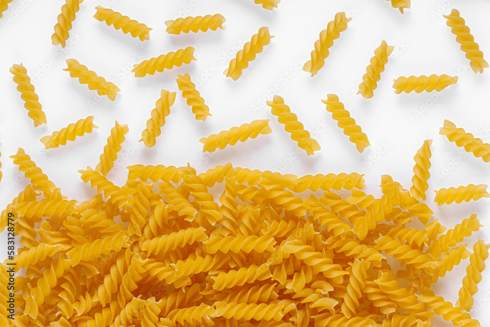 Pasta products in the form of a spiral, texture, on a white background Pasta products in the form of a spiral, texture, on a white background
