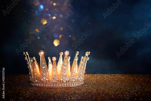 Fotografiet low key image of beautiful queen or king crown over glitter table