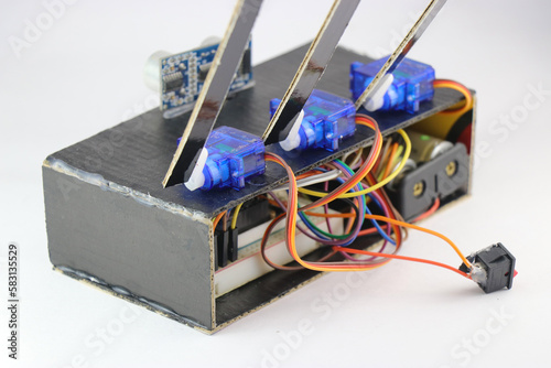 Micro servos or plastic servo motors are connected to a breadboard and micro controller using jumper wires in an interactive electronics project photo