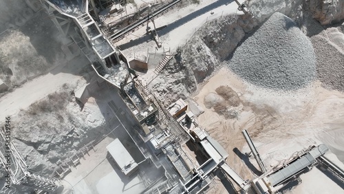 Work at a huge limestone quarry, production of aggregates., heavy machines in action, transferring the material, crusher complex, travel with ships