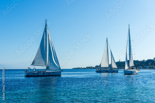 boats and yachts at the sailing regatta on open water. Sailing on the wind waves in the sea.