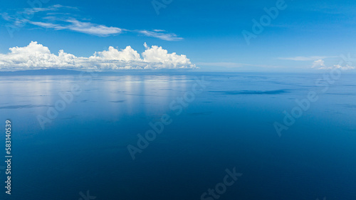 Top view of blue sea against the background of the sky and clouds. Semporna, Sabah, Malaysia.
