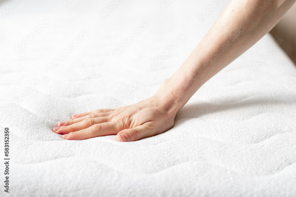 woman touching soft white mattress indoors, closeup - obrazy, fototapety, plakaty 