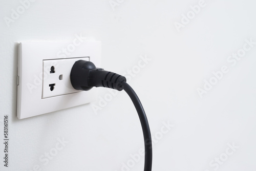 Close Up the electrical power socket and plug socket on wall.