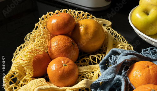 orange, mandarin, fresh fruit on yellow cloth bag, blue bag
 photo