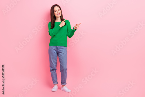 Full body photo of pretty positive lady indicate fingers empty space proposition isolated on pink color background