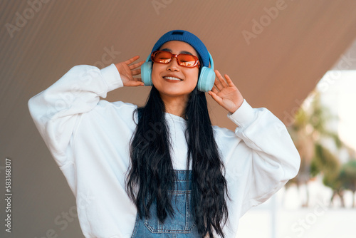 Asian woman wearing headphones