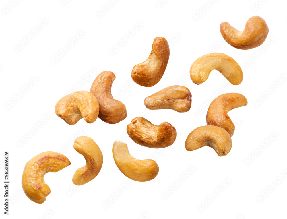 Roasted cashews flying on a white background. Isolated Roasted cashews flying on a white background. Isolated