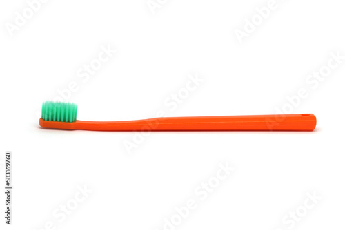 Orange plastic toothbrush with green bristles  white background  side view