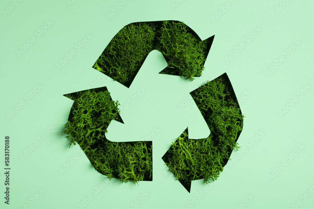 Green moss under paper cut recycling symbol. Save planet, eco, recycling concept Green moss under paper cut recycling symbol. Save planet, eco, recycling concept