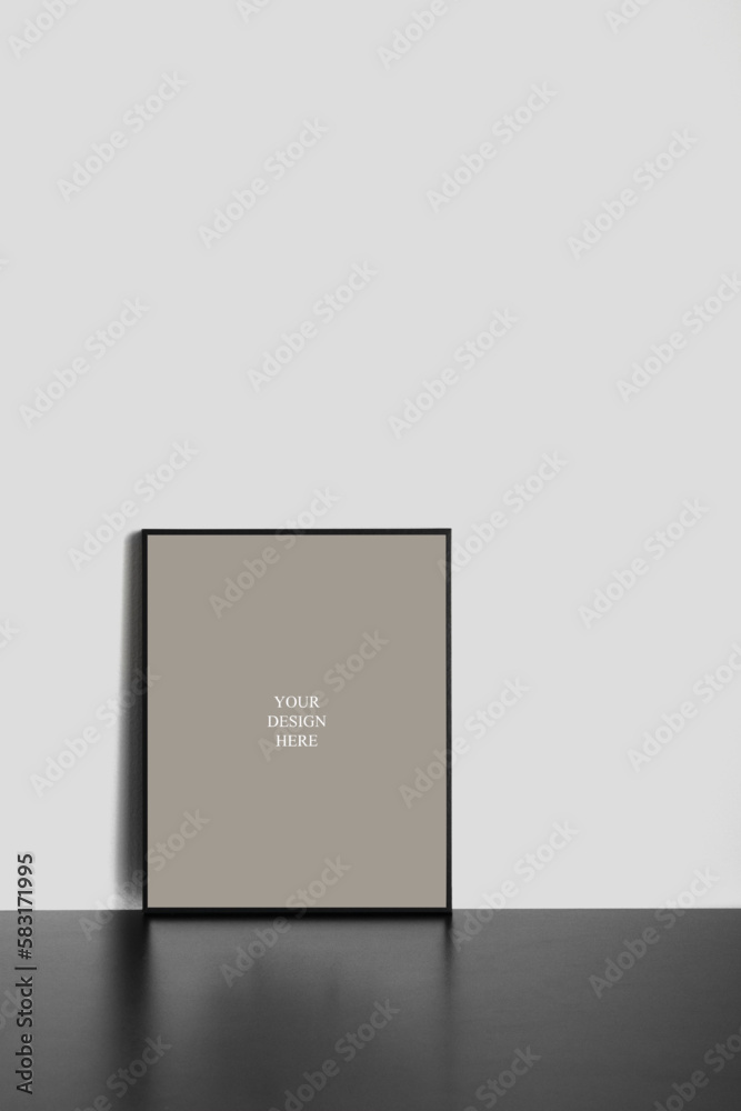 Vertical Frame Mockup on Black Wooden Desk with Natural Shadows Vertical Frame Mockup on Black Wooden Desk with Natural Shadows